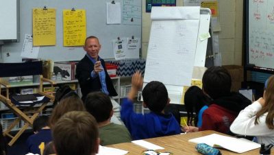 Author Rob Buyea speaks at the front of a classroom