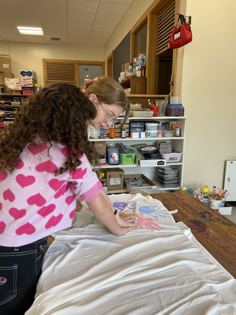 Teacher and student make a handprint dress