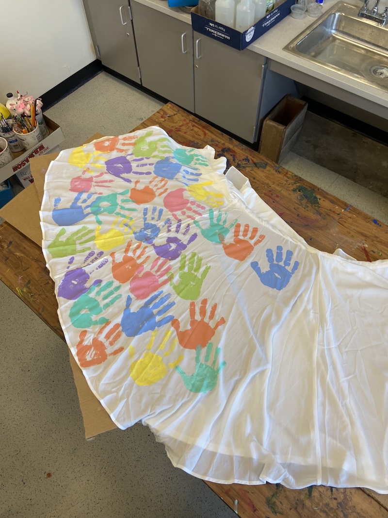 A dress full of colorful handprints