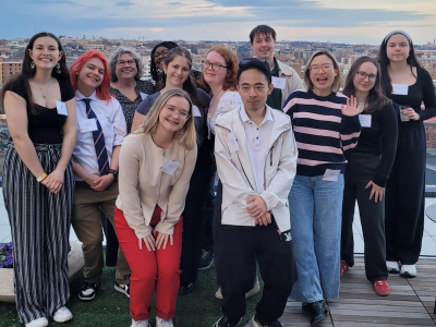 A group of undergraduates pose for a photo on a rooftop