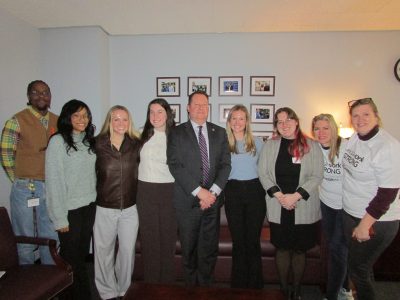 A group of students bwith a New York assemblyman