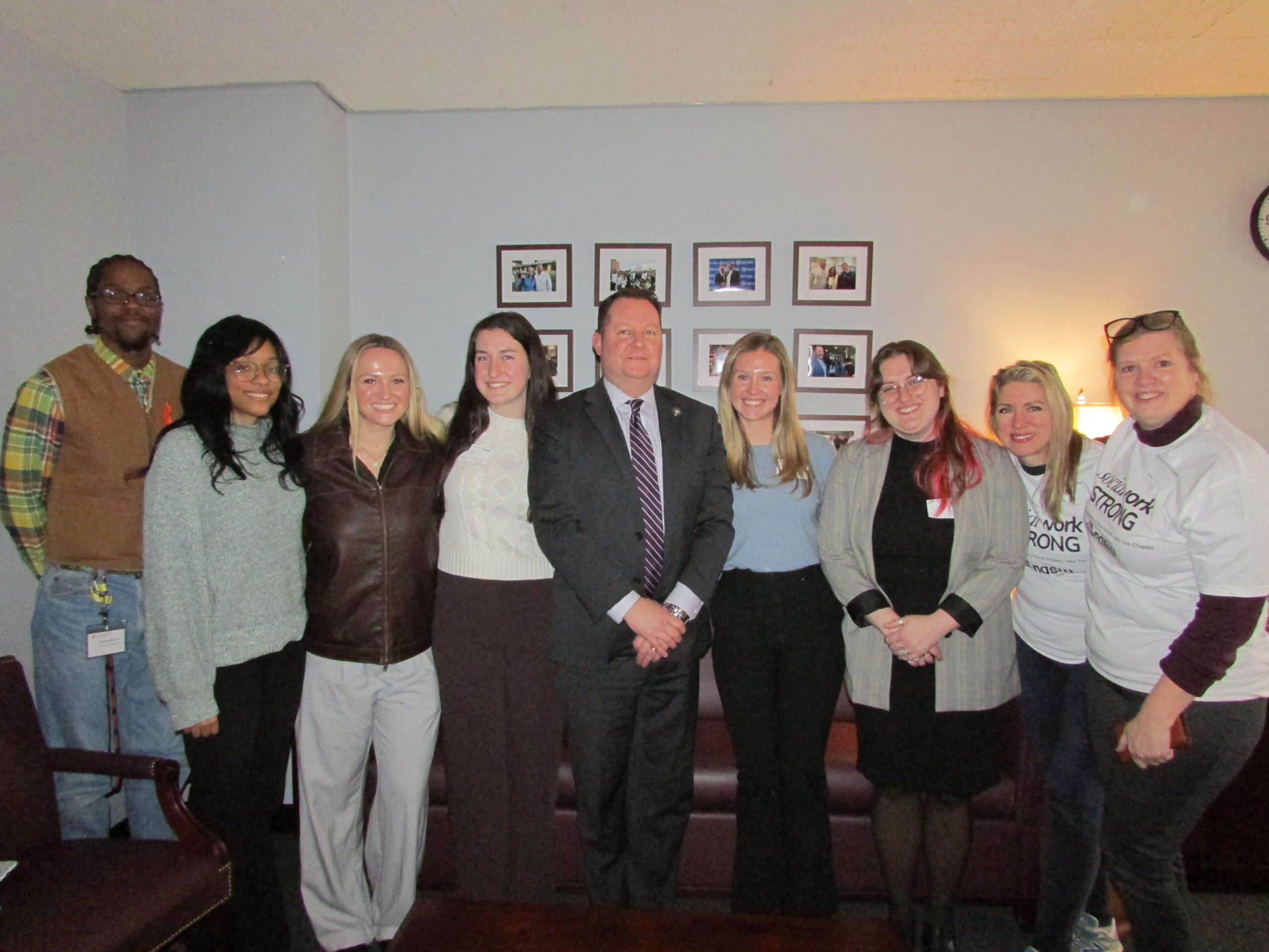 A group of students bwith a New York assemblyman
