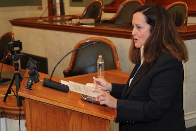 Rachael Gazdick offers remarks from a podium