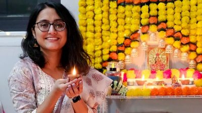 Saraswati Dhakal lighting a candle