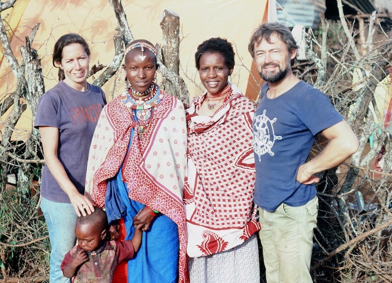 Two Kenyan women stand with Suzanne Grant Lewis and her husband
