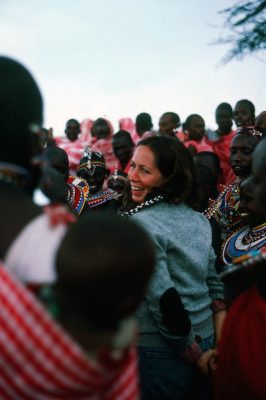 Suzanne Grant Lewis in the middle of a group of dancing Kenyan women
