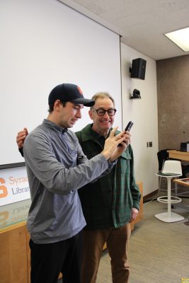 Two people take a selfie with a smartphone