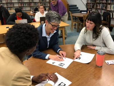 Leela George, center, working with educational leadership doctoral students