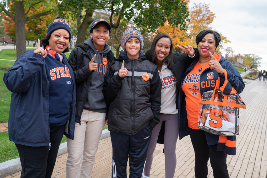 savannah stocker and her family in syracuse gear during family weekend