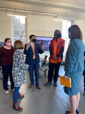 John mannion speaks with three inclusiveu students and prof beth myers in the huntington hall commons