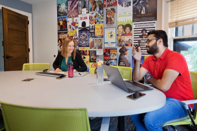 Nicole Fonger at desk with Waleed Raja.