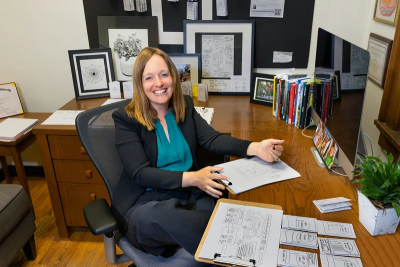 Nicole Fonger sits at a desk