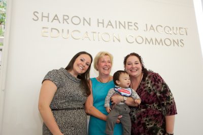 Sharon Jacquet (center) with family at the dedication of the Sharon Haines Jacquet Education Commons in May 2013