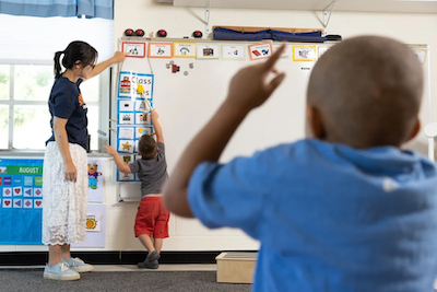 Emily Liu points to her white board