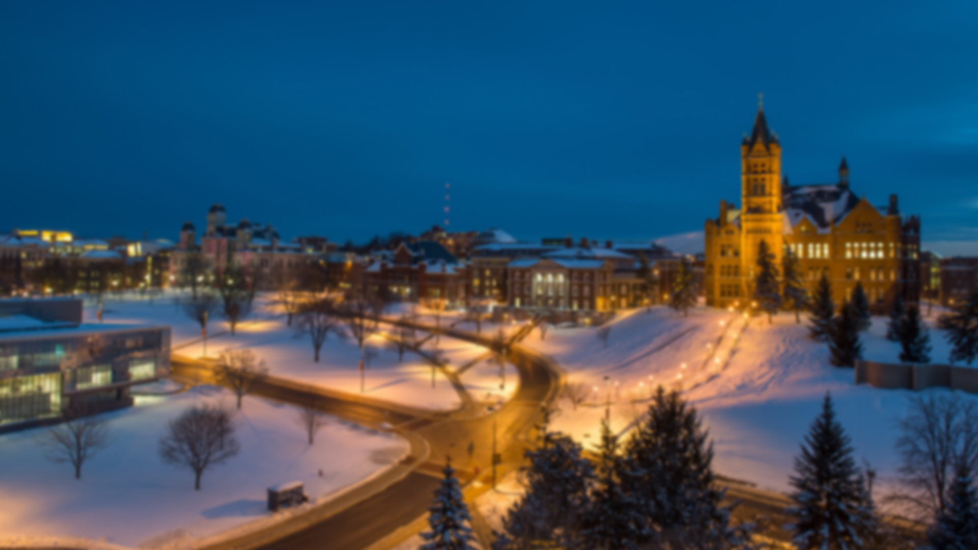 wide campus shot of crouse college, maxwell, eggers, and newhouse on a snowy night