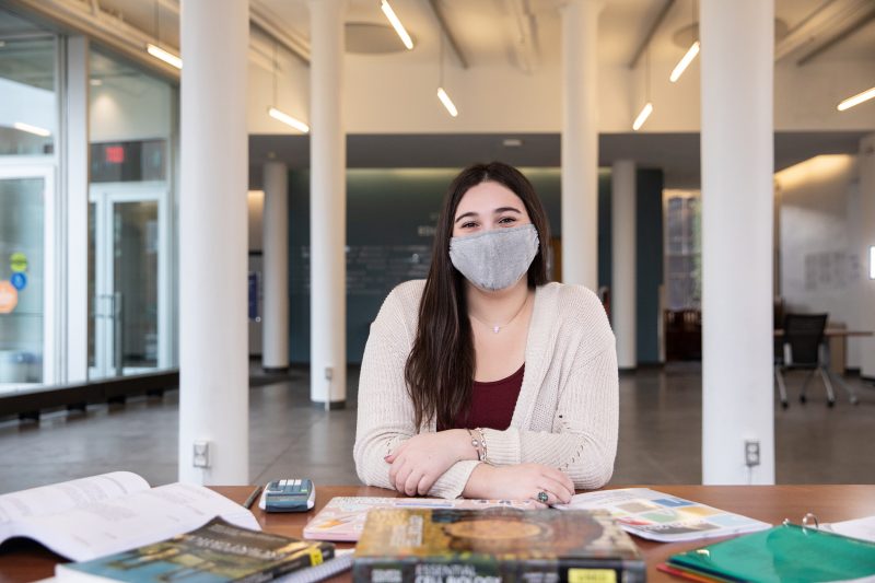 Sydney Ringel sits in the huntington hall commons doing lesson planning
