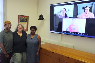 Group of people standing in front of a zoom screen